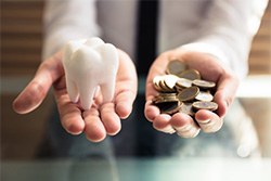 Tooth balanced with a pile of coins