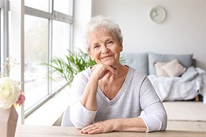 Woman smiling while sitting at table in living room